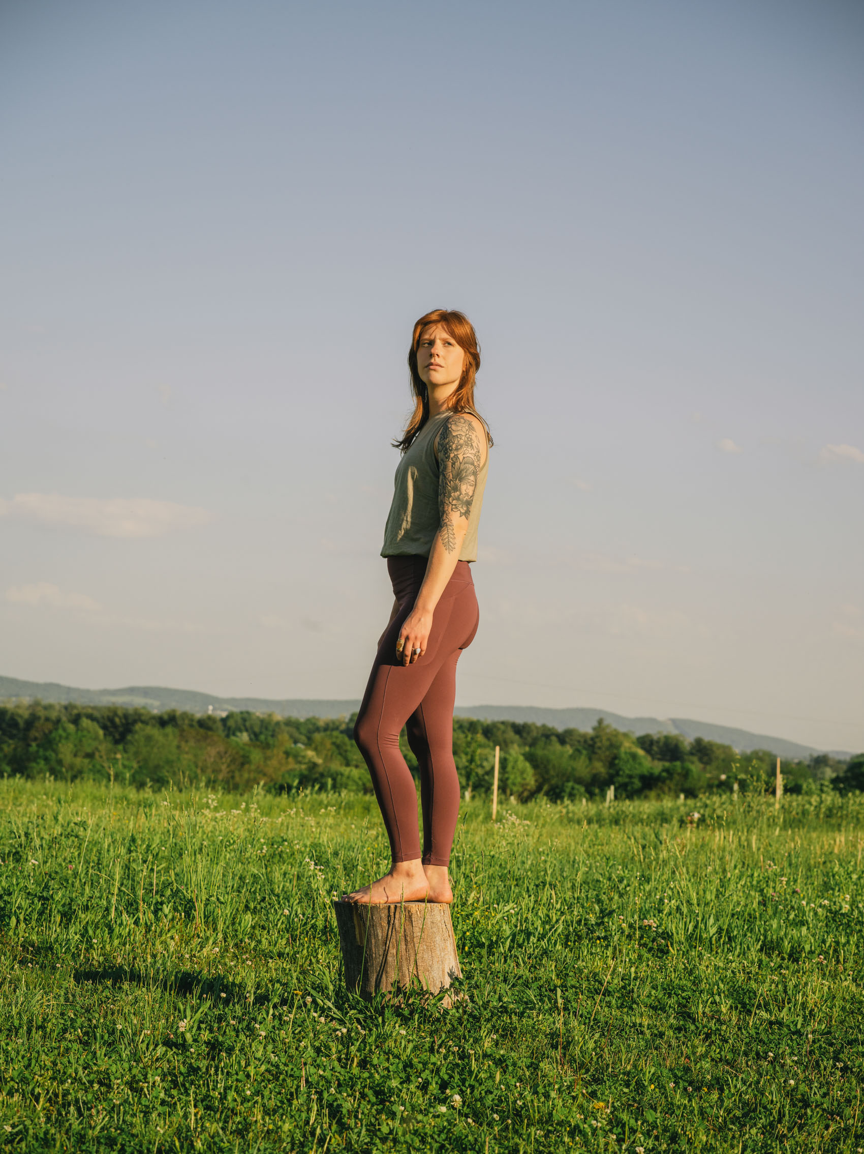 woman standing on tree stump lifestyle  photography for Arcteryx 