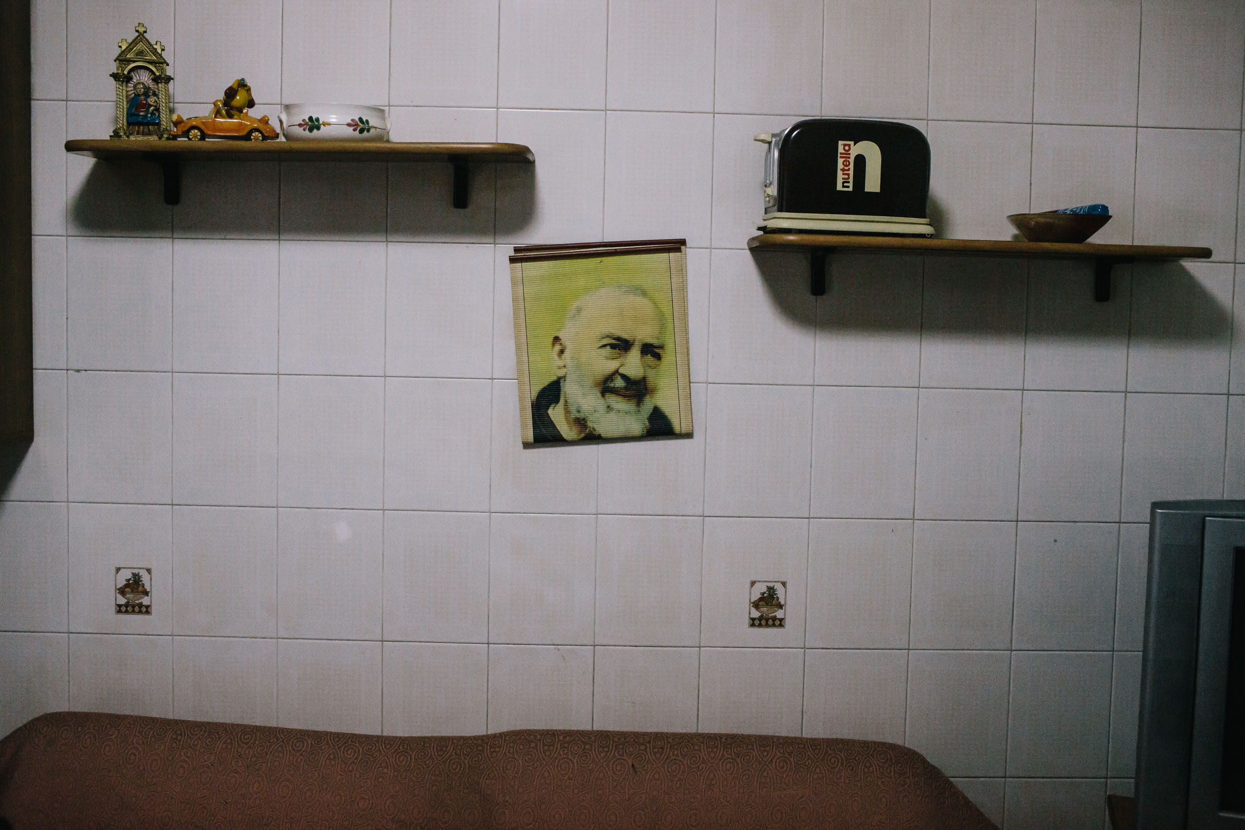 An image of Saint Padre Pio hangs in the kitchen