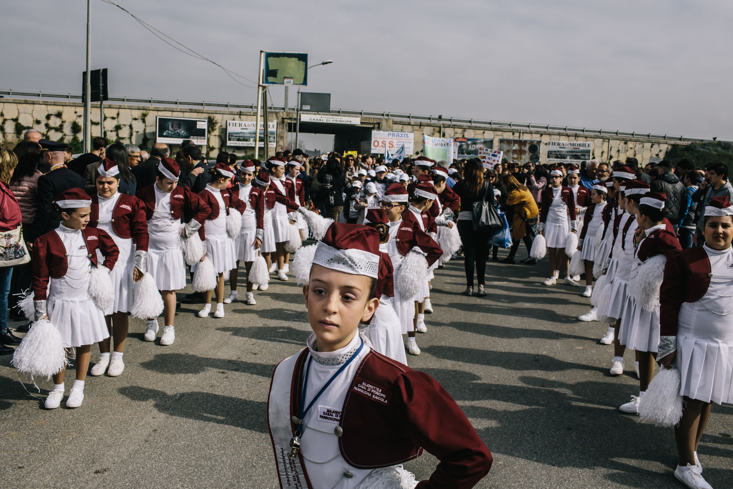 Children in a marching group stand in formation before the start of a protest 