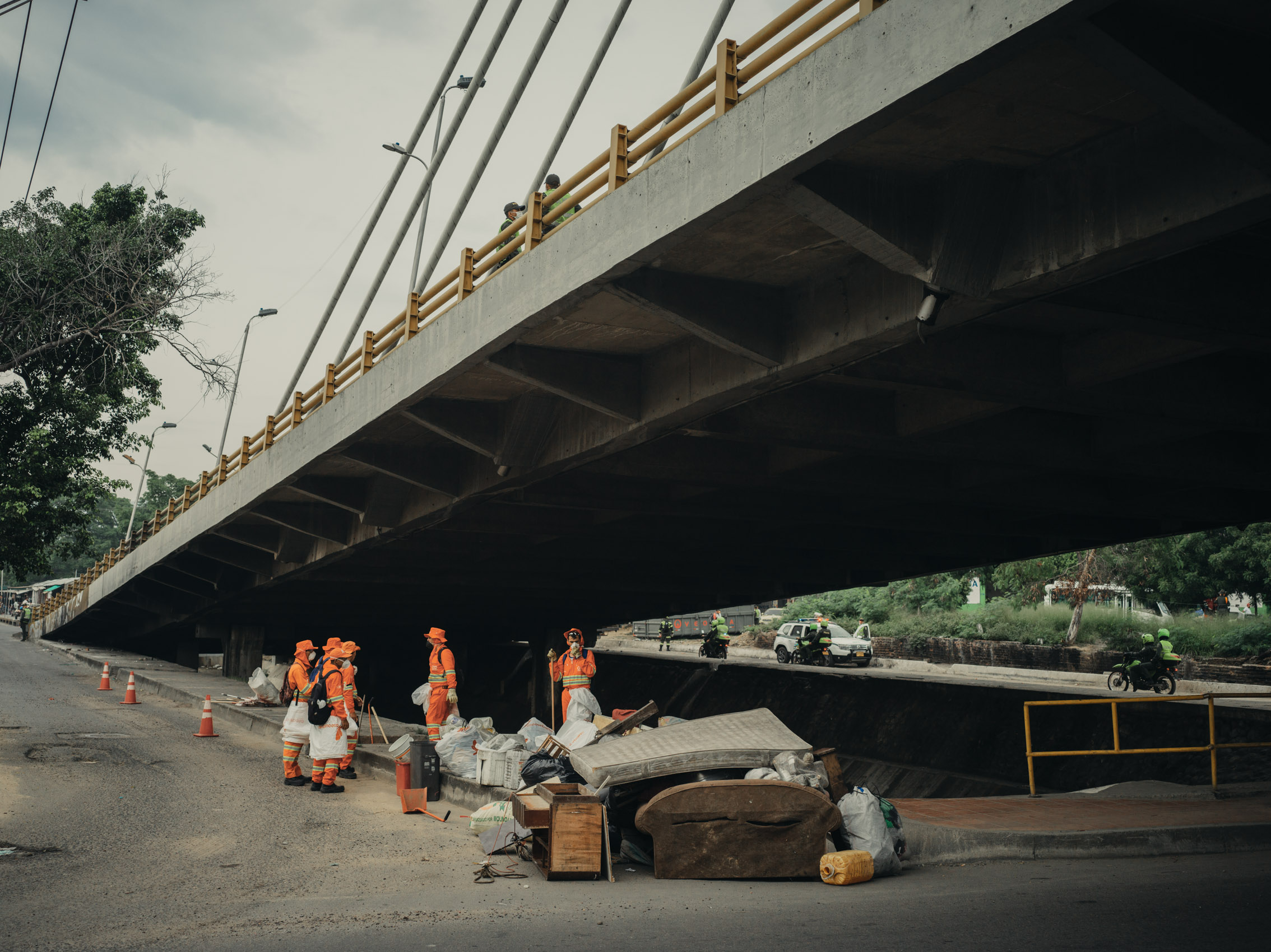 Trash cleanup under bridge in Colombia