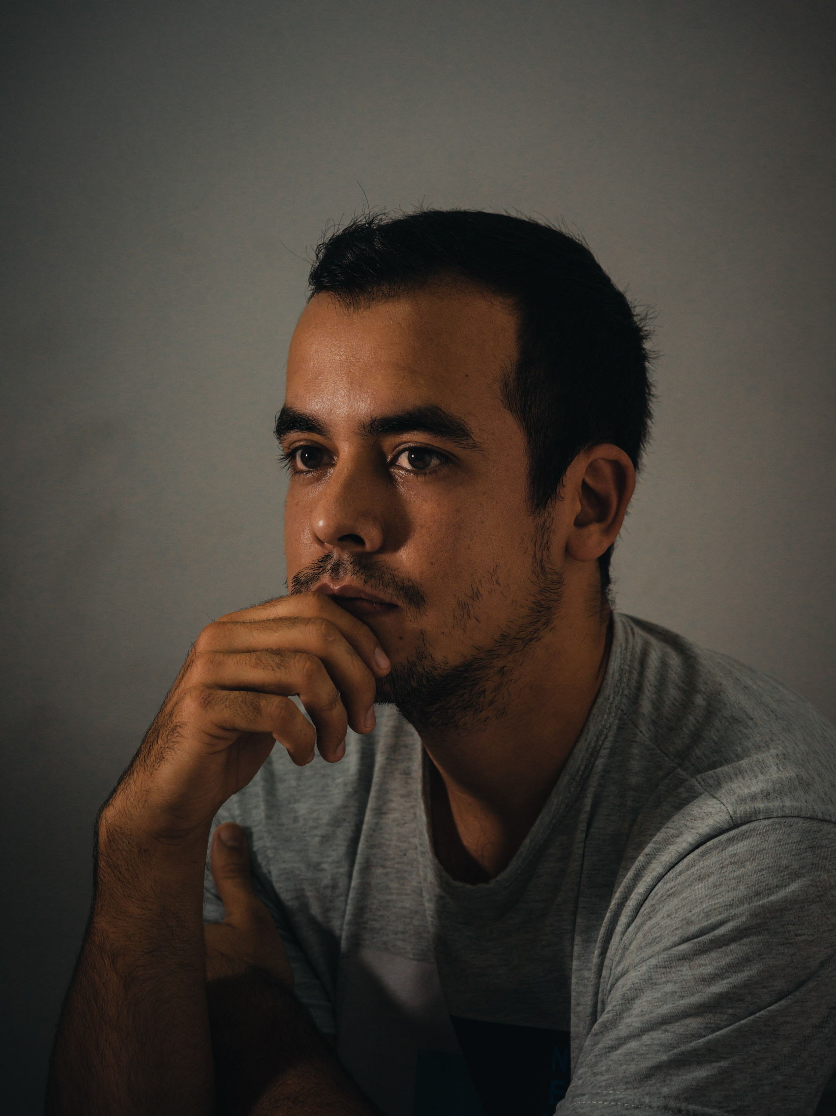 portrait of man with hand on chin