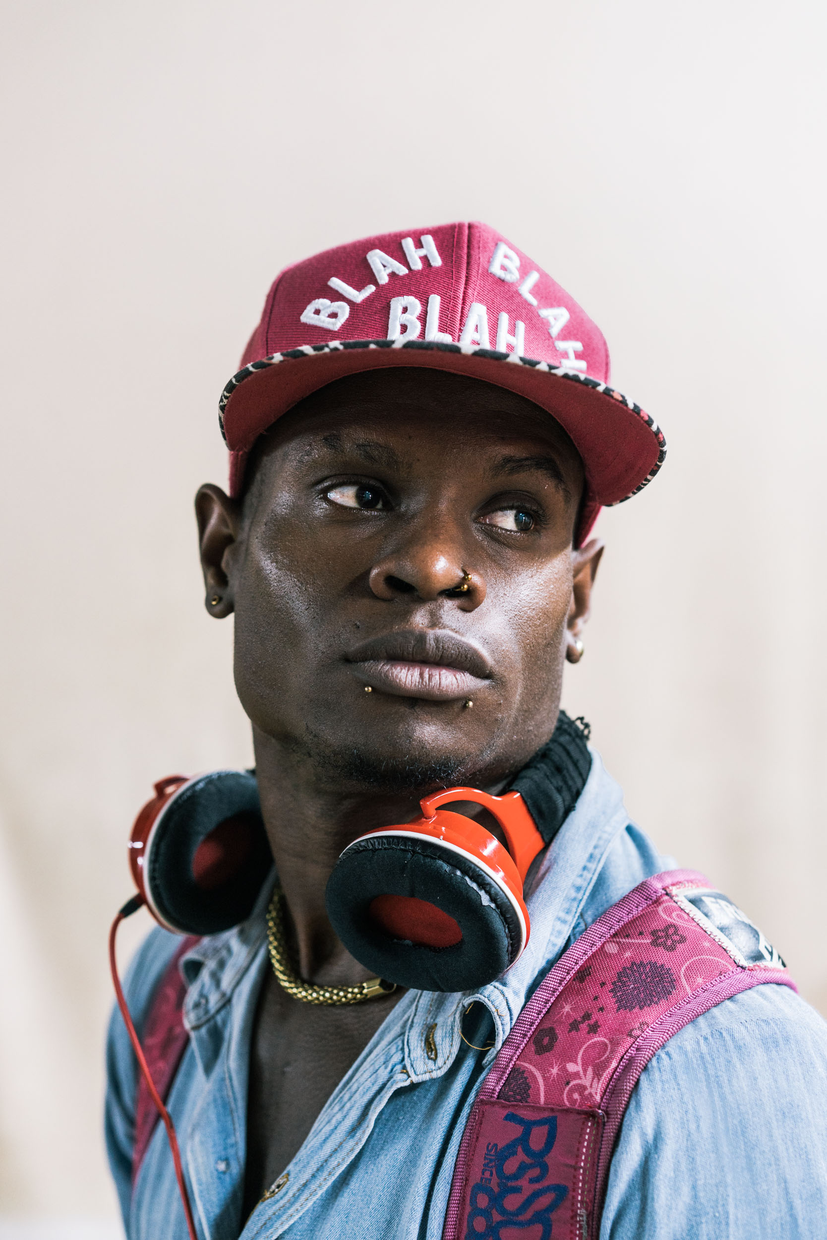 portrait of man with pink hat and headphones