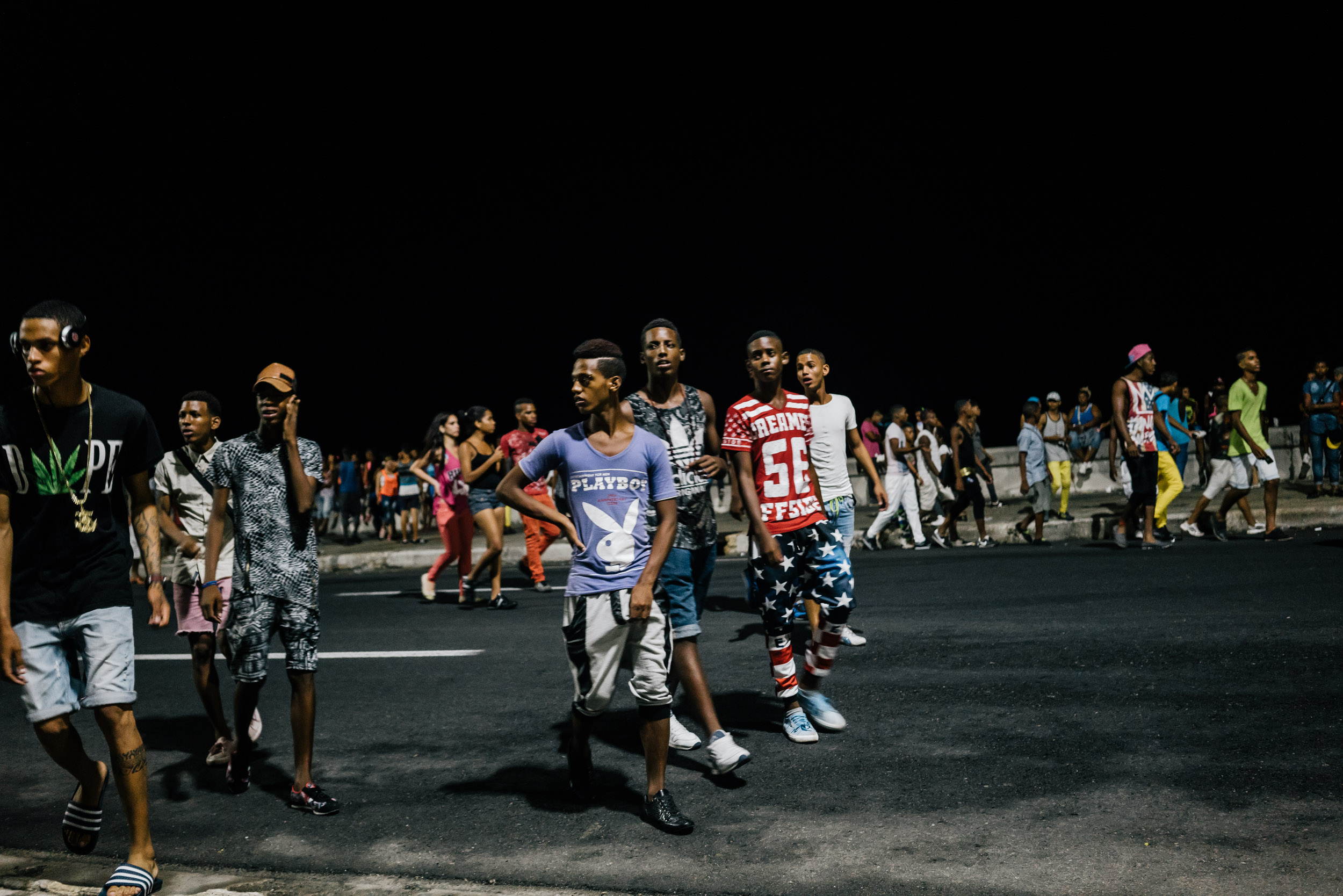 people partying at night along the Malecón in Havana