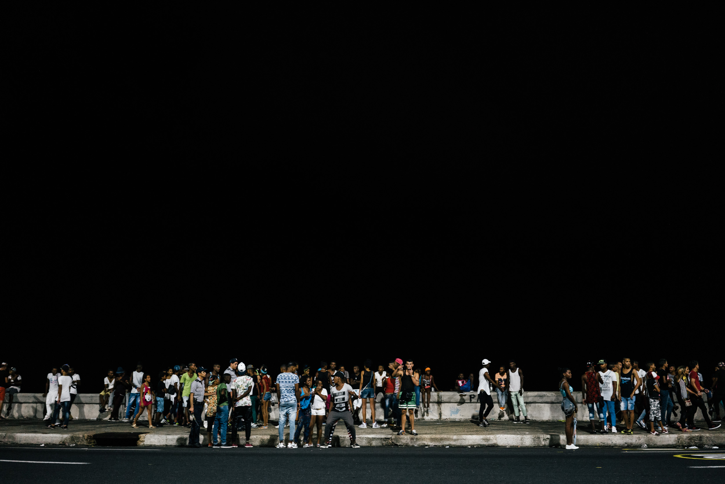 crowd partying at night along the Malecón in Havana