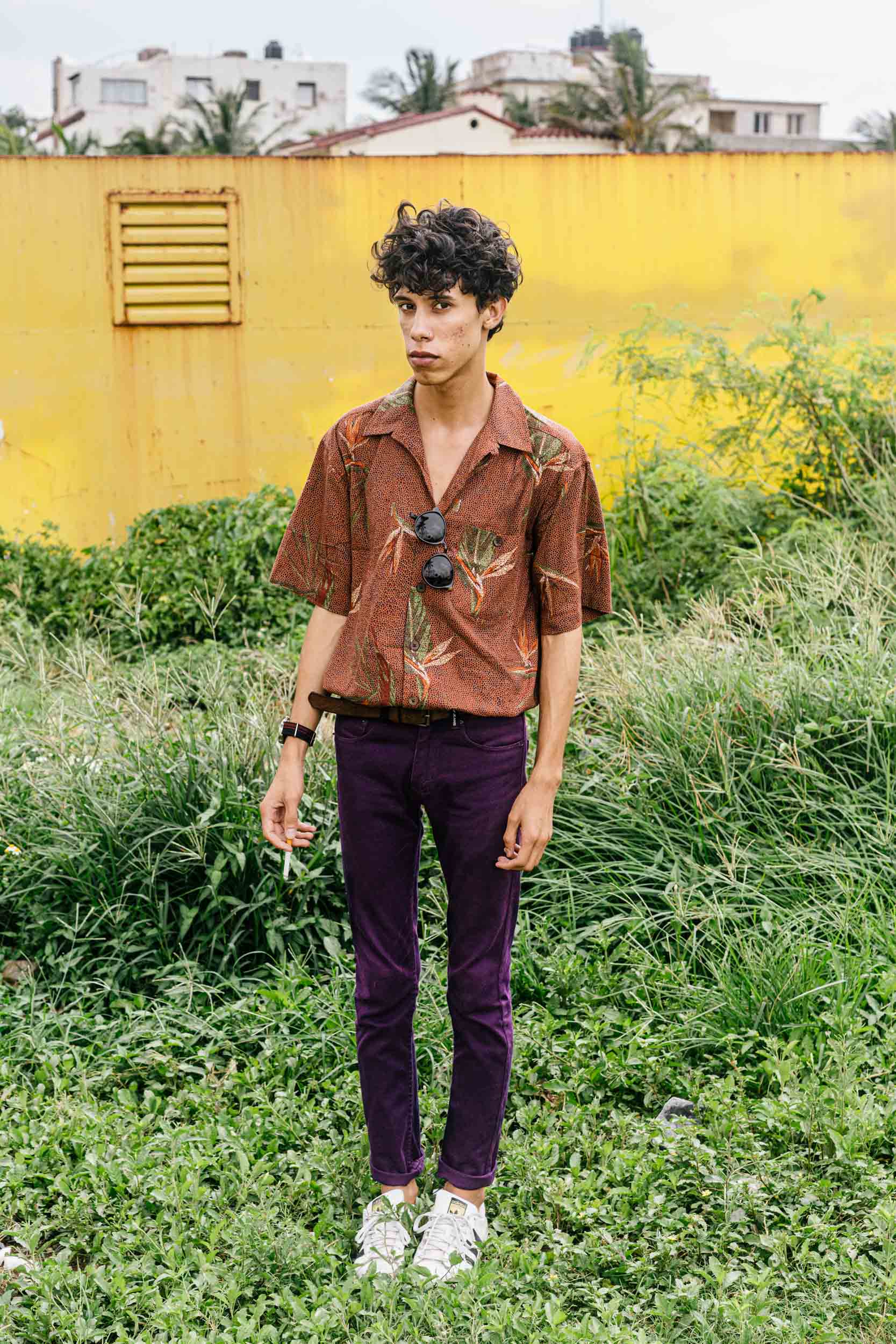 portrait of fashion blogger in purple pants with yellow wall