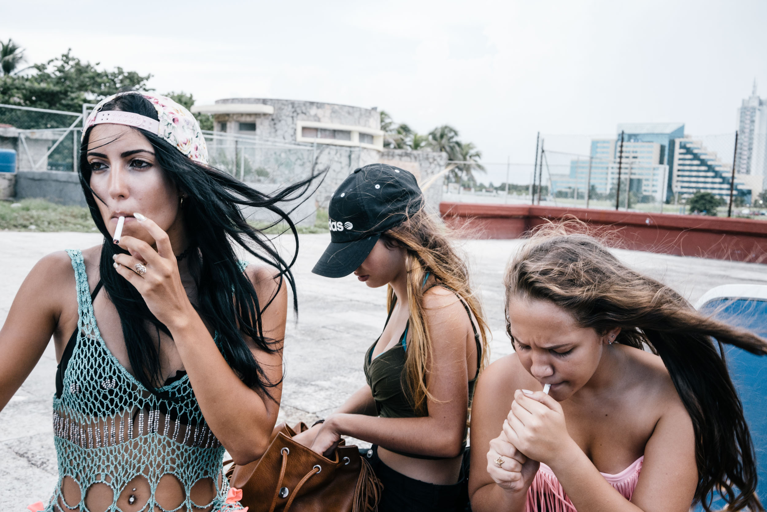 girls smoke at pool party in bathing suits